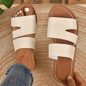 Chic open toe flat sandals in beige white with double strap detail.