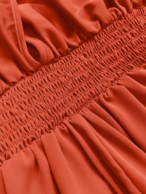 Orange-red maxi dress with smocked bodice and V-neck detail