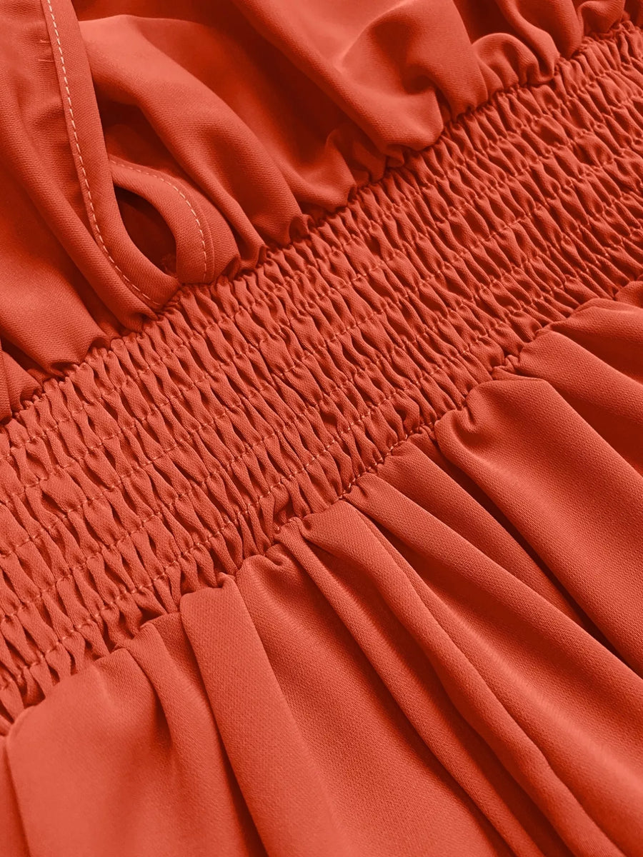 Orange-red maxi dress with smocked bodice and V-neck detail