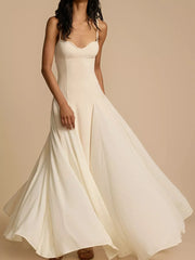 Elegant sweetheart neck maxi dress in ivory with a flowing skirt.