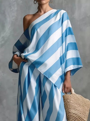 Blue and white striped one-shoulder top and wide-leg pants set.