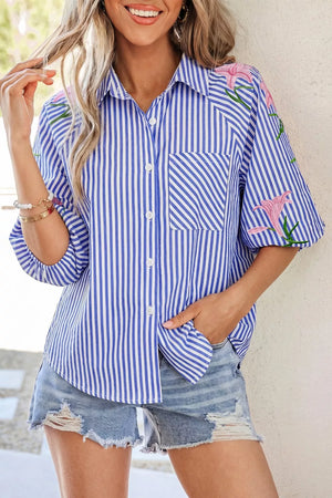 Blue and white striped button-down shirt with floral embroidery and pocket