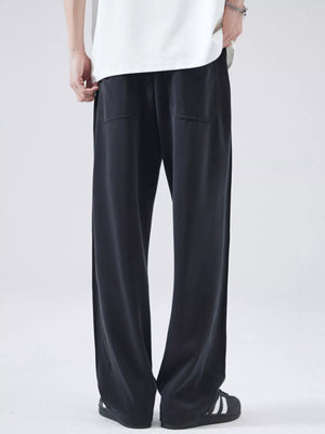 Black relaxed fit drawstring casual pants with two front pockets.