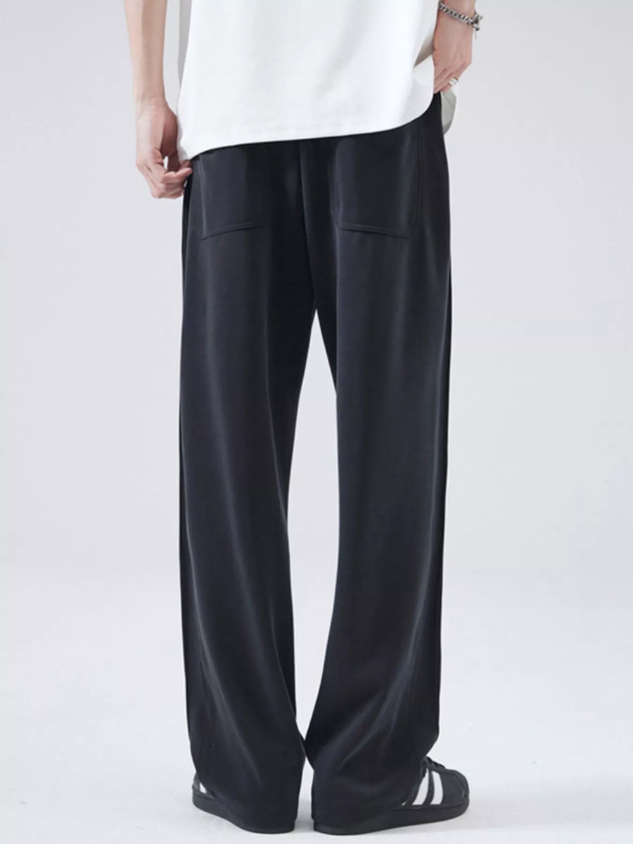 Black relaxed fit drawstring casual pants with two front pockets.