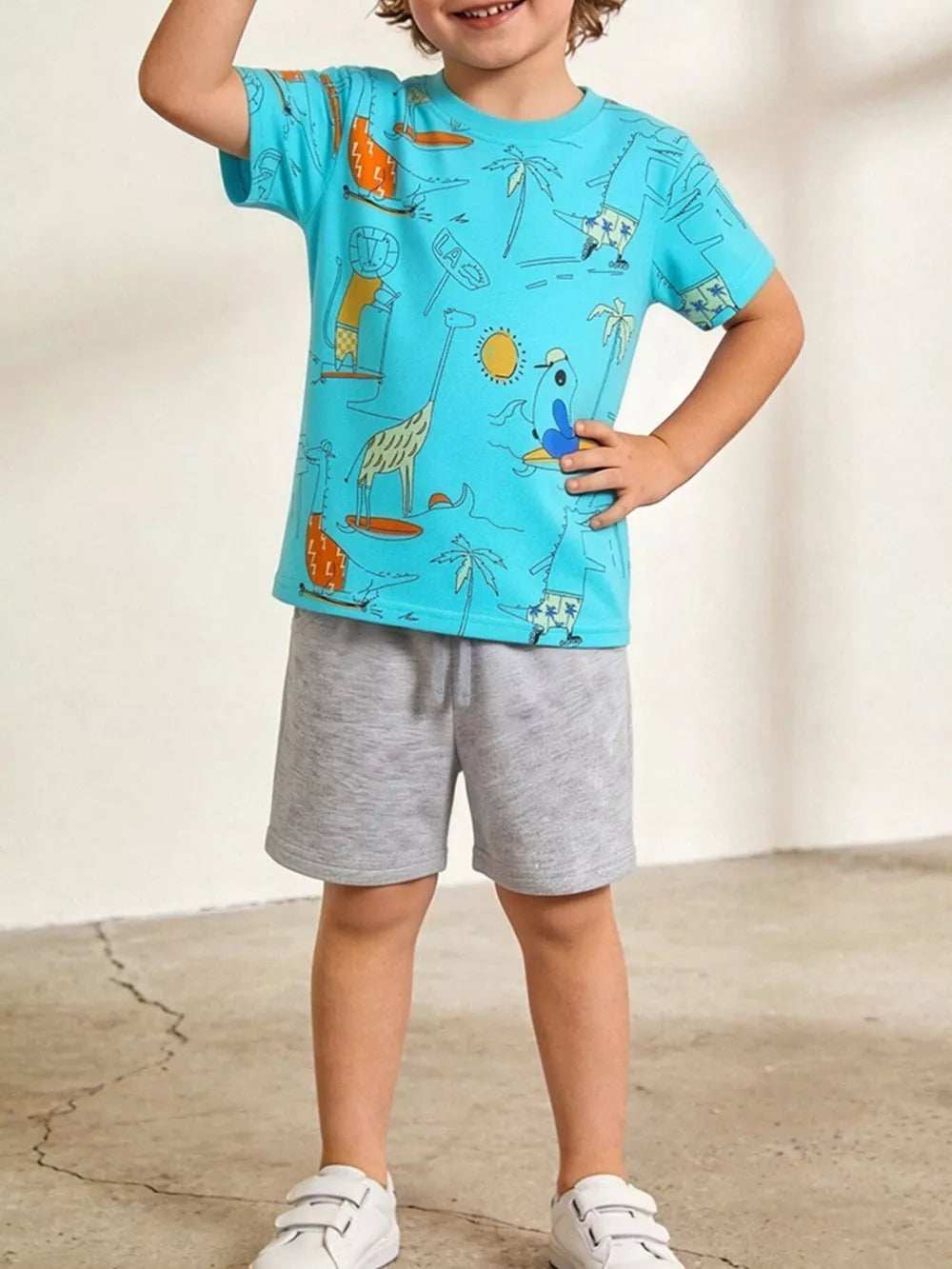Boys' blue cotton t-shirt with whimsical animal adventure print and grey shorts.
