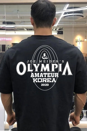 Black oversized tee with Joe Weider's Olympia Amateur Korea 2020 graphic print.