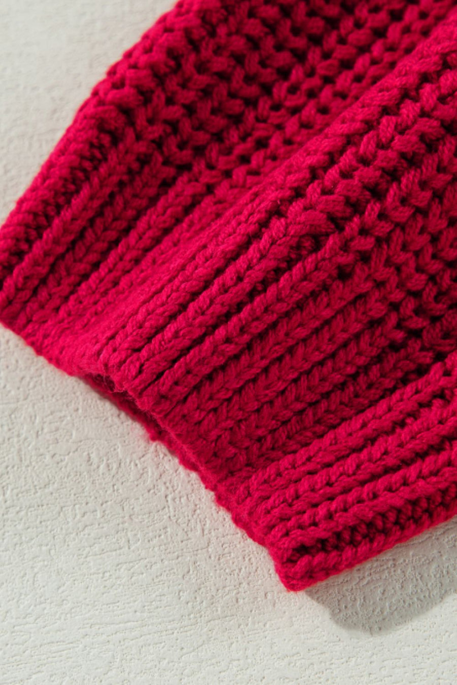 Deep red acrylic knit sweater with ribbed texture detail