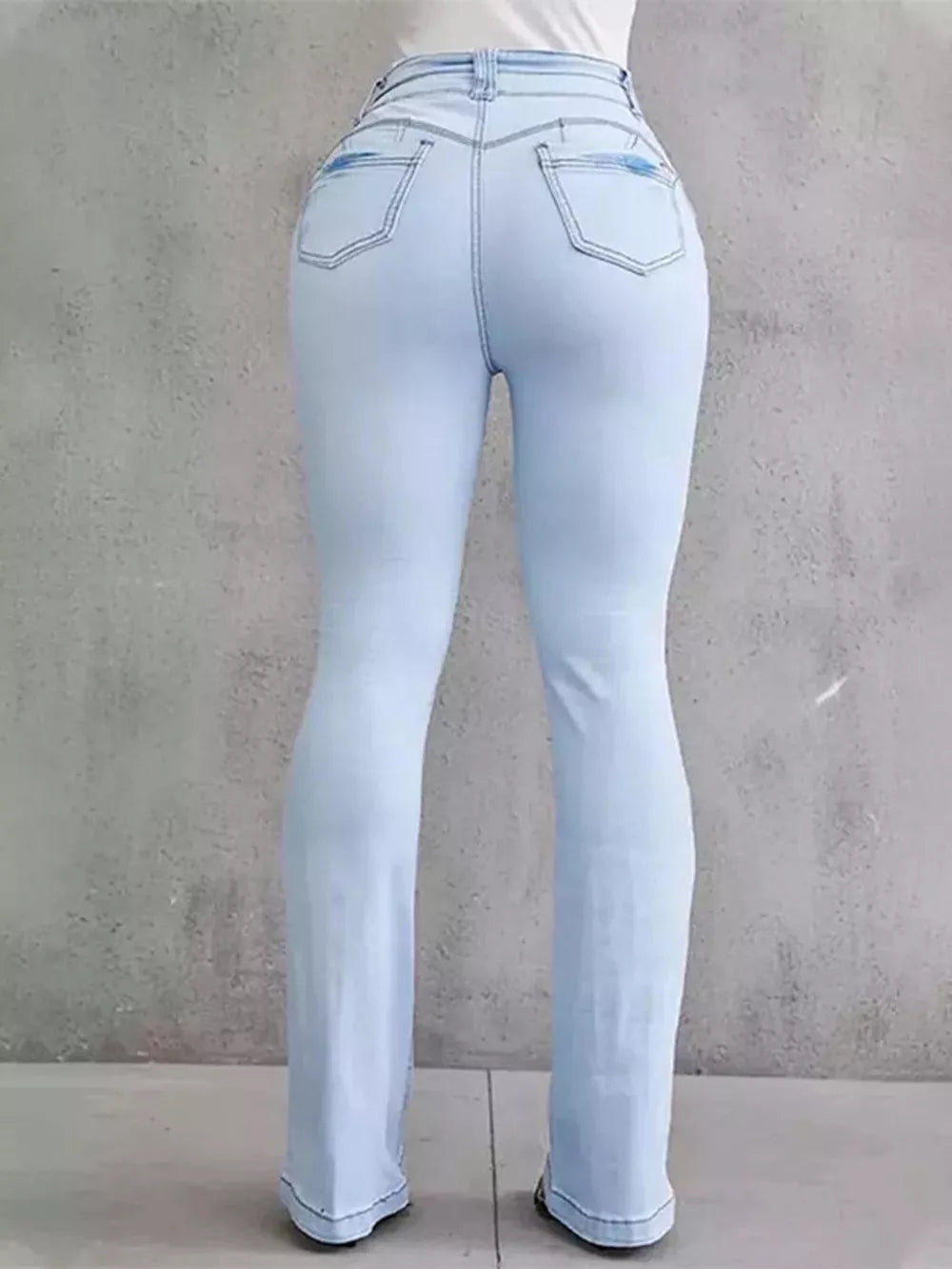 Light blue high-waisted flare jeans with button closure and pocket details.