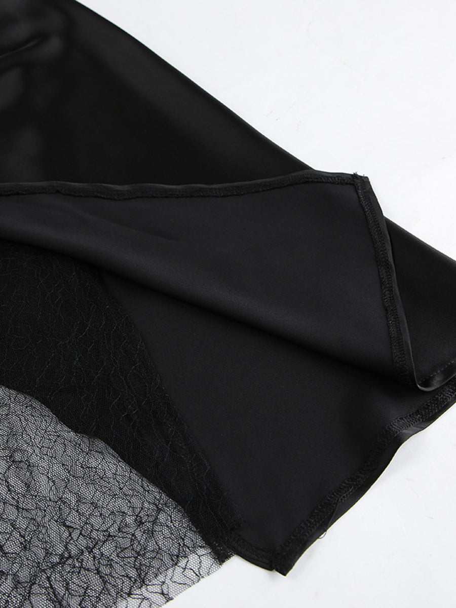 Black midi skirt with sheer lace panel detail and asymmetrical hem.