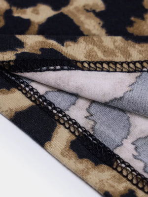 Leopard print midi dress detail showing fabric texture and stitching.
