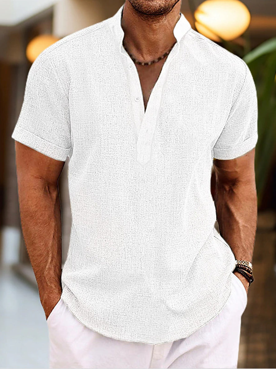 Men's white short sleeve cotton blend henley shirt with buttoned placket and mandarin collar.