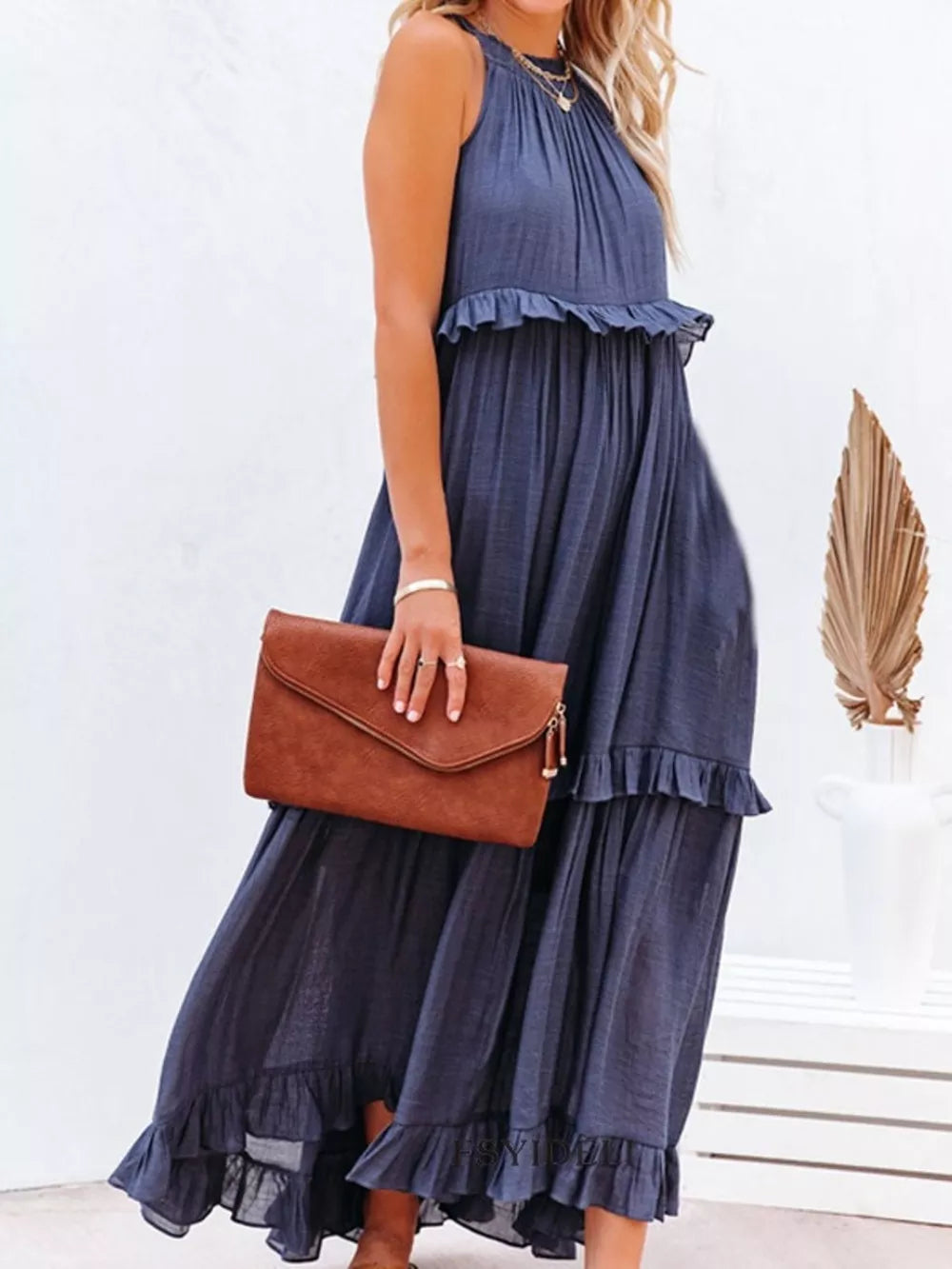 Navy ruffled maxi dress with halter neckline and tiered skirt.