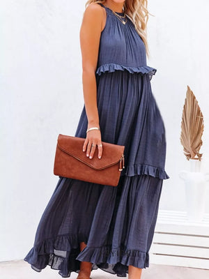 Navy ruffled maxi dress with halter neckline and tiered skirt.