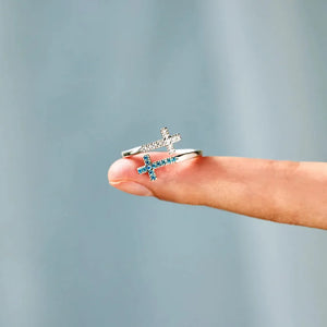 Sterling silver ring with intertwined crosses, one with clear stones, one with blue zircon.