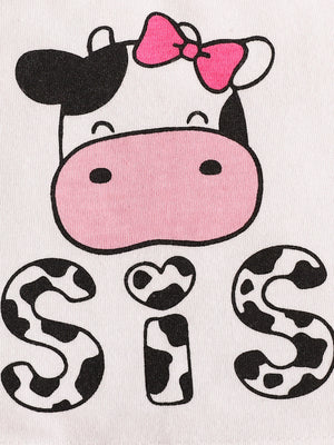Baby cow print tank top with pink bow and "Sis" graphic on white cotton.