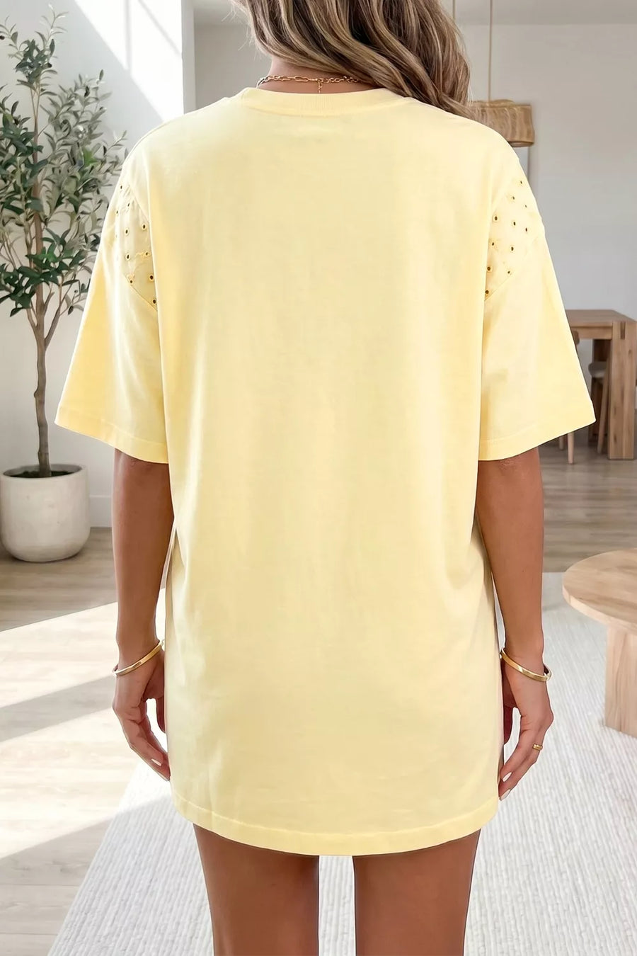 Yellow cotton t-shirt with short sleeves and eyelet detail on shoulders.