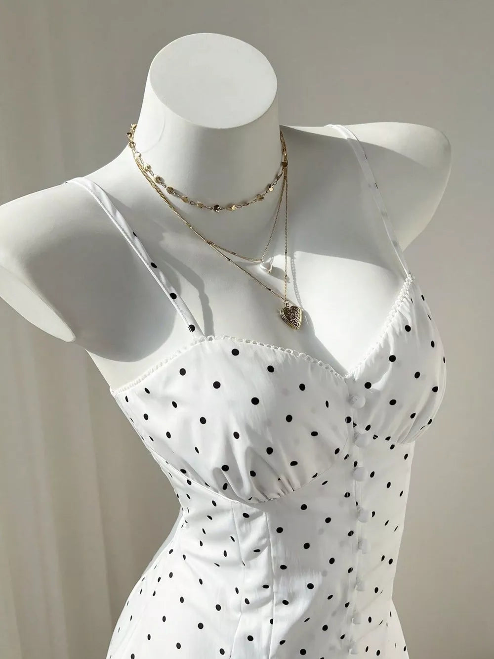 White mini dress with buttoned and spaghetti strap
