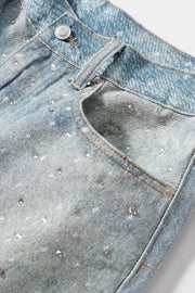 Embellished denim bermuda shorts in medium wash with allover rhinestones and pocket detail.