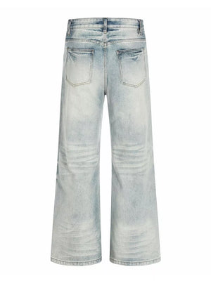 Men's light blue vintage wash wide leg jeans with distressed details.