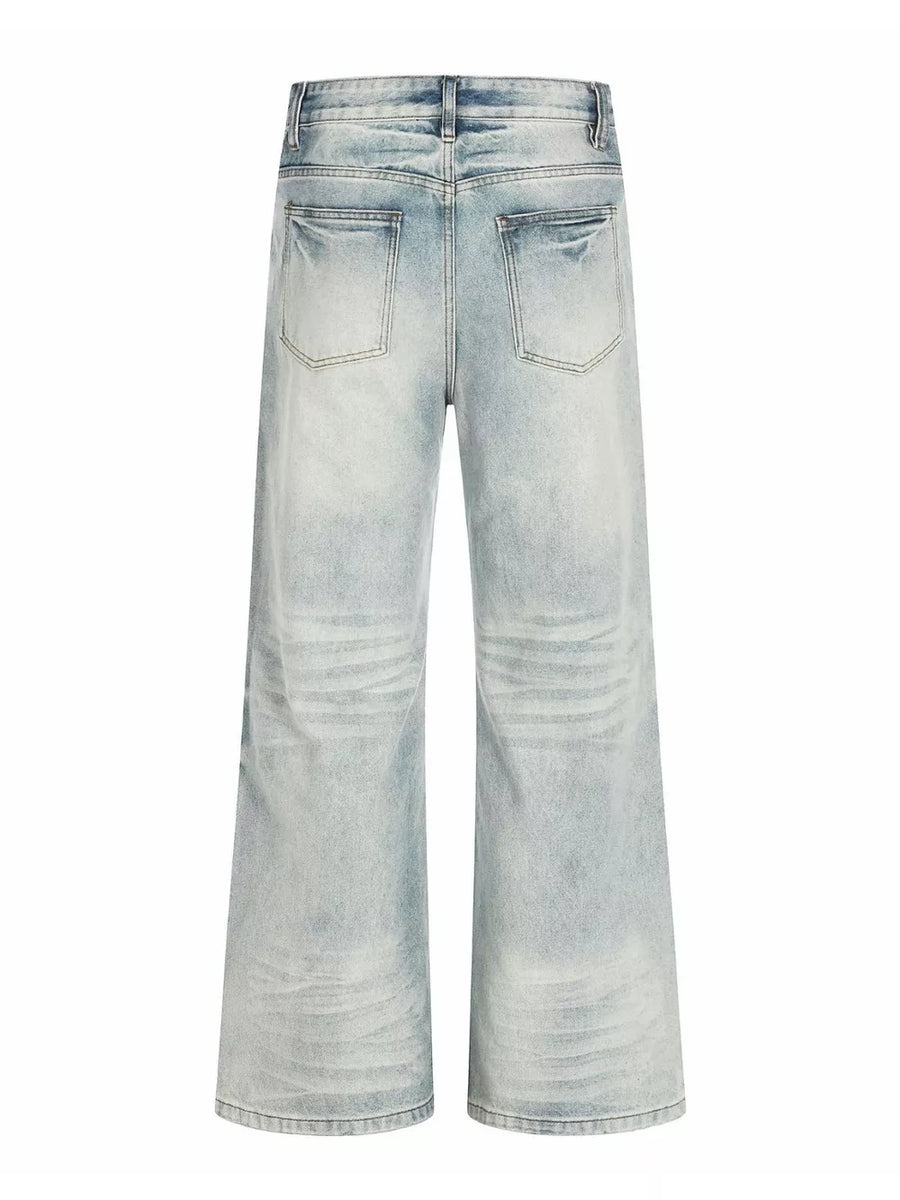 Men's light blue vintage wash wide leg jeans with distressed details.