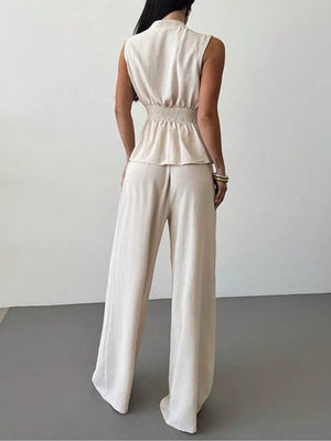 Sleeveless wrap top with smocked waist and wide-leg pants set in beige polyester.