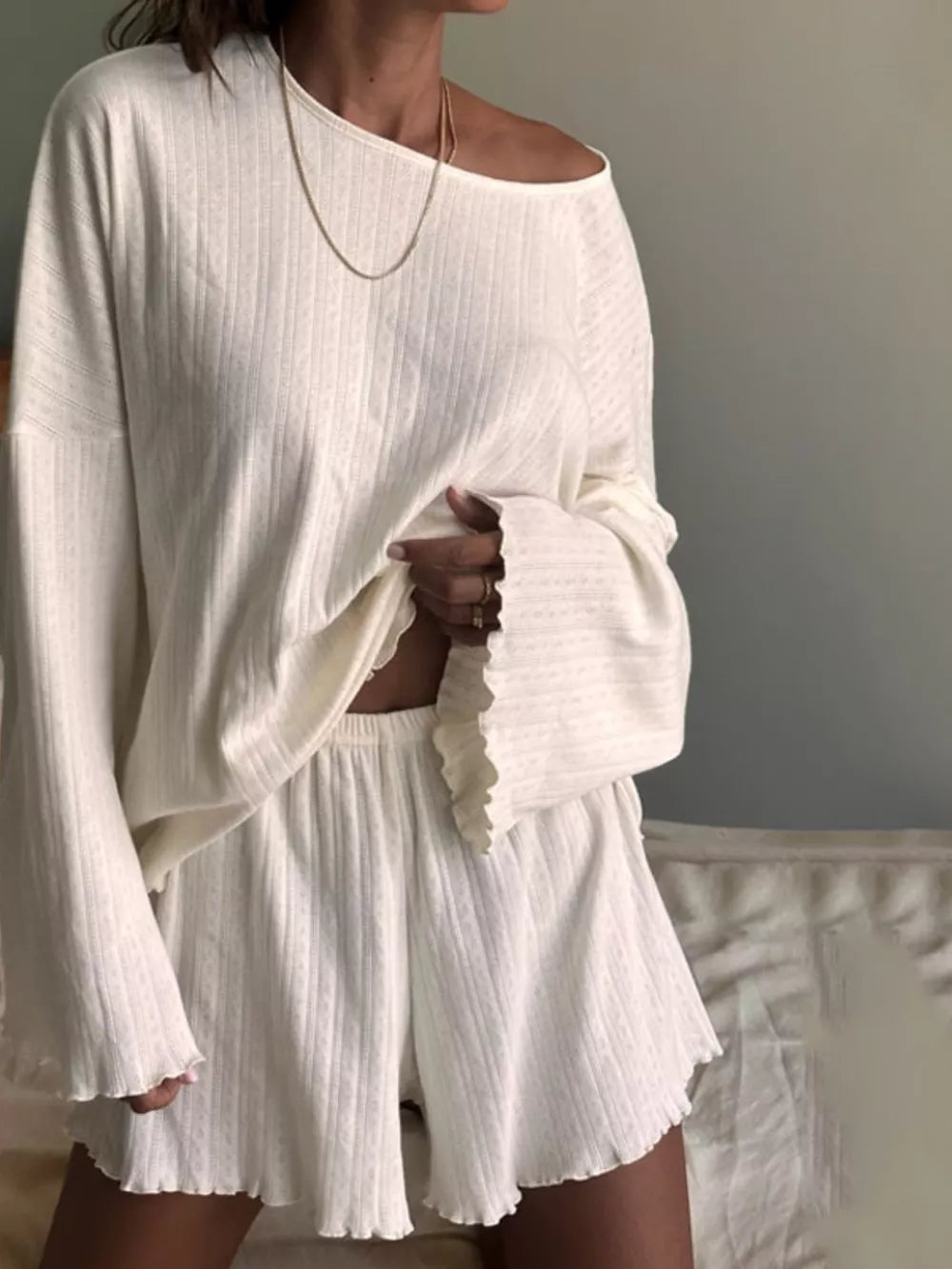 White ribbed knit lounge set with lettuce trim shorts and off-the-shoulder top.