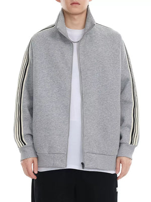 Plus-size grey zip-up sweatshirt with contrast stripe detail on sleeves and mock neck.