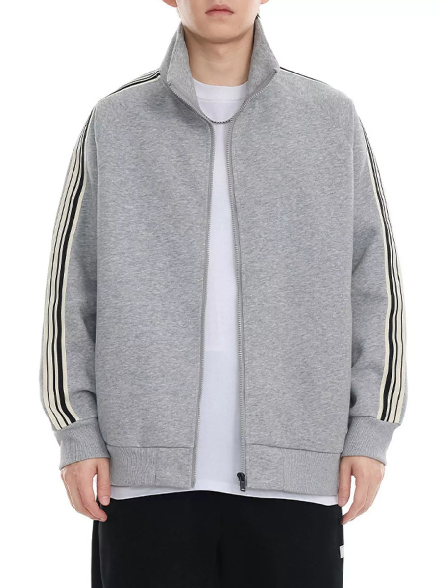 Plus-size grey zip-up sweatshirt with contrast stripe detail on sleeves and mock neck.