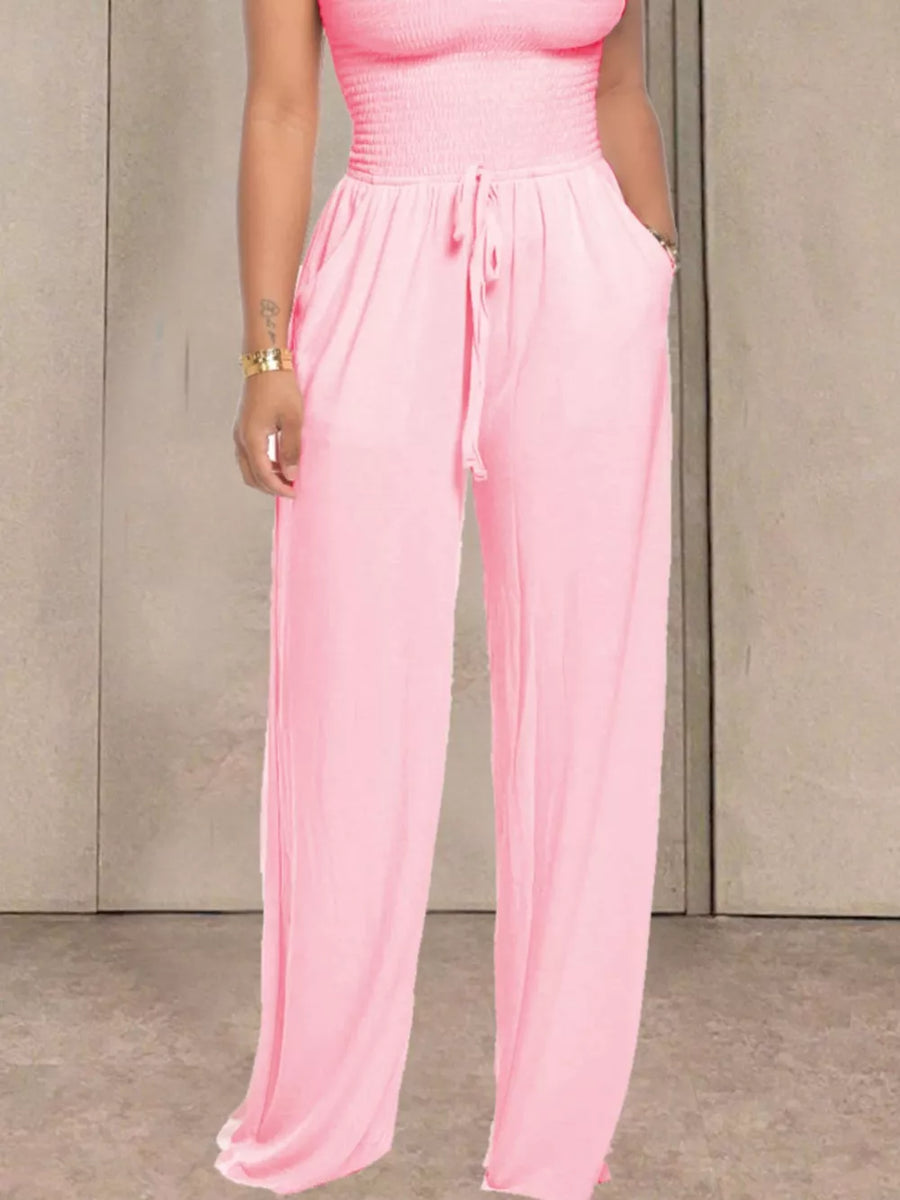 Pink wide leg jumpsuit with smocked bodice and drawstring waist