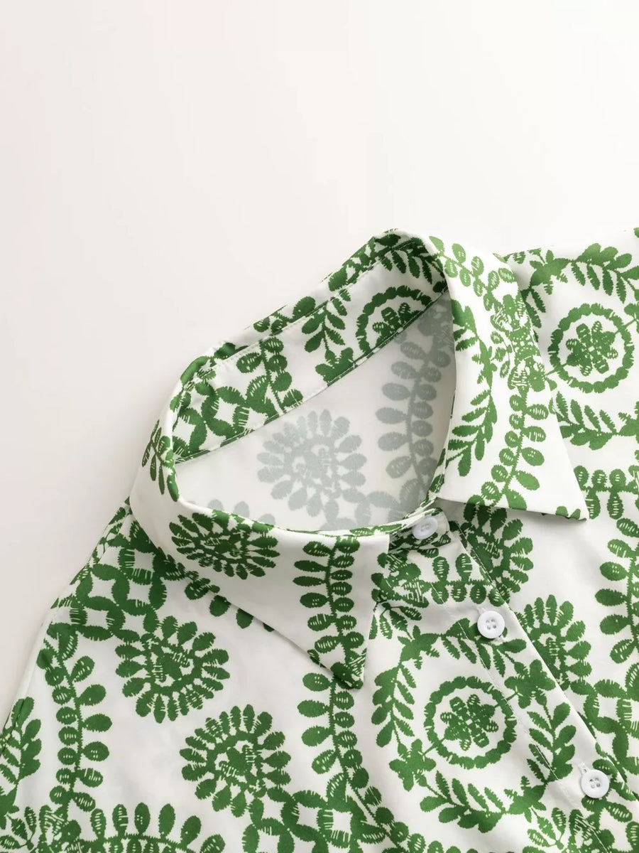 Green printed tie-waist romper with button front and collar detail