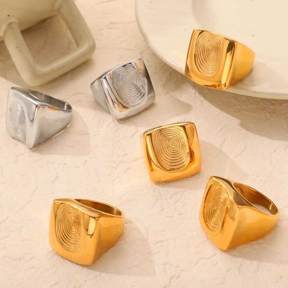 Gold and silver signet rings with sculpted fingerprint detail