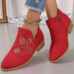 Red suede ankle boots with gold floral embroidery and side zip.
