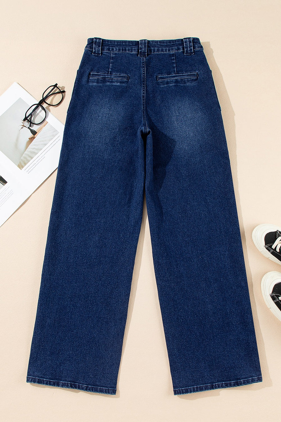 Mid-rise straight leg jeans in dark wash denim with button closure and two back pockets.