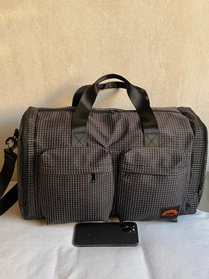 Chic medium plaid duffel bag with front pockets and black handles