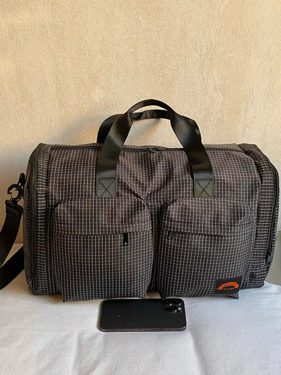 Chic medium plaid duffel bag with front pockets and black handles