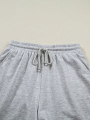 Grey polyester lounge pants with drawstring waist and elastic waistband.