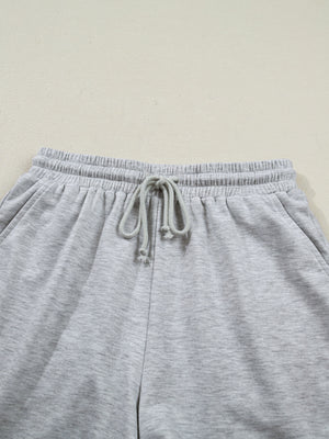 Grey polyester lounge pants with drawstring waist and elastic waistband.