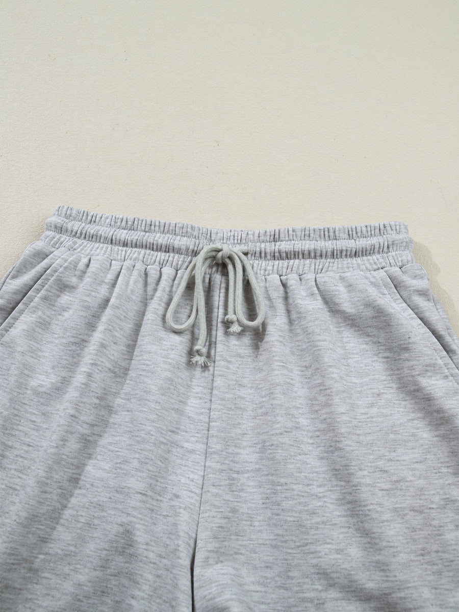 Grey polyester lounge pants with drawstring waist and elastic waistband.