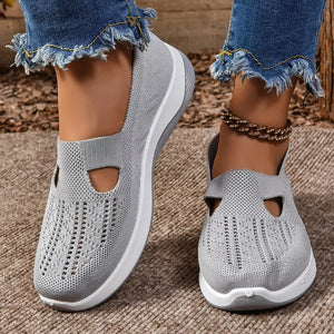 Grey breathable mesh slip-on shoes with white soles and cut-out details.