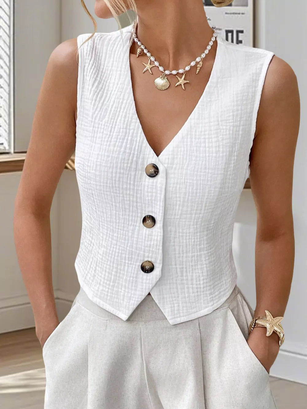 White textured cropped vest with tortoiseshell buttons and V-neck