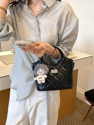 Black crossbody bag featuring quilted and quilted
