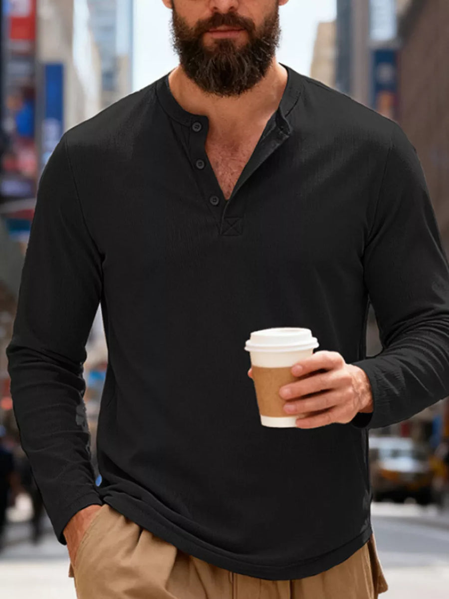 Men's black long-sleeve henley t-shirt with button placket and relaxed fit.