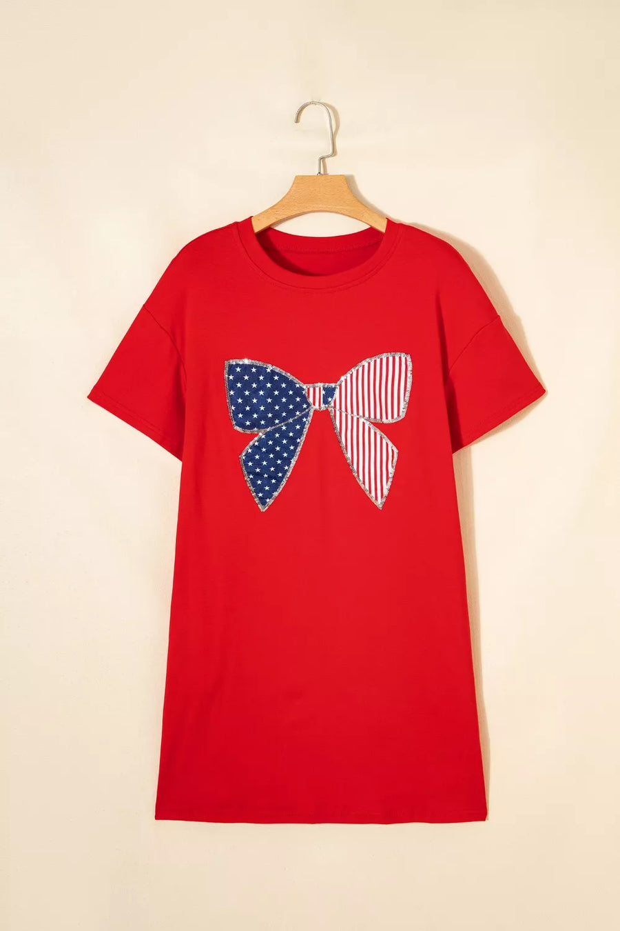Red cotton mini dress with a sequined stars and stripes bow graphic.