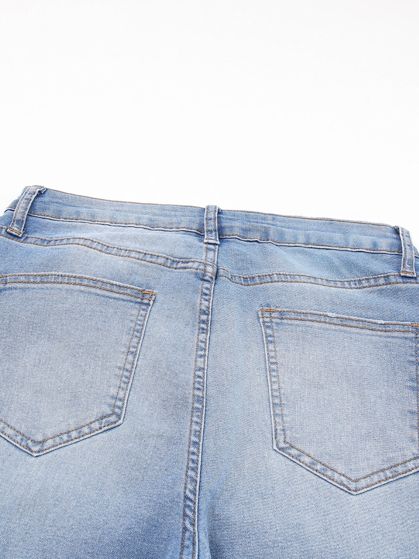 Light wash denim cropped jeans with whiskered details and back pockets.