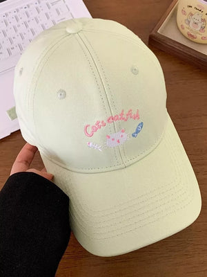 Light green baseball cap with embroidered cats and fish design