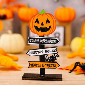 Spooky signpost decor with jack-o-lantern, Candy Warehouse, Haunted House, and Tricks & Treats signs.