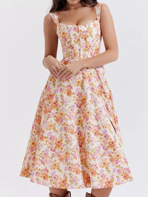 Floral midi dress with side slit, sweetheart neckline, and corset bodice in a pink and orange floral print.