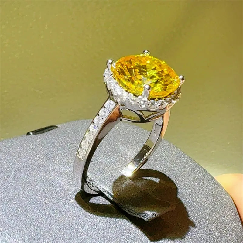 Sterling silver ring with a large yellow moissanite and halo of small diamonds.