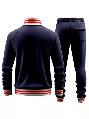 Navy blue tracksuit with red and white striped collar, cuffs, and hem
