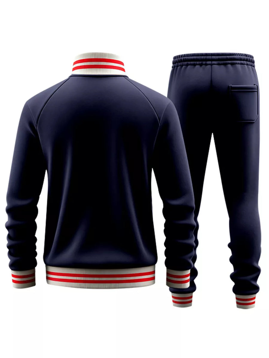 Navy blue tracksuit with red and white striped collar, cuffs, and hem